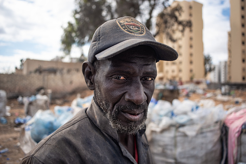 a portrait of a migrant from Mali working in collecting plastic to recycle it in the outskirts of Tripoli-Libya.