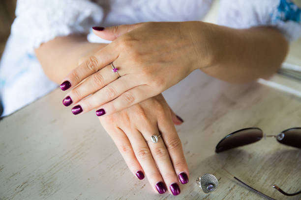 istock Woman's hand with ring holding cup of cappuccino 1251737393