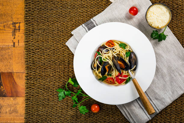 istock Spaghetti with Mussels and Tomatoes on Wooden Background 1251738236