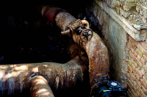 istock An open underground pipeline with valves in a brick well. 1251738430