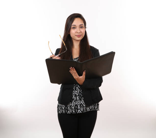 istock Young Office Assistant Holds Glasses and Portfolio 1251738686