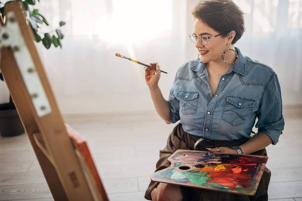 istock One young female artist painting in her studio 1251738794