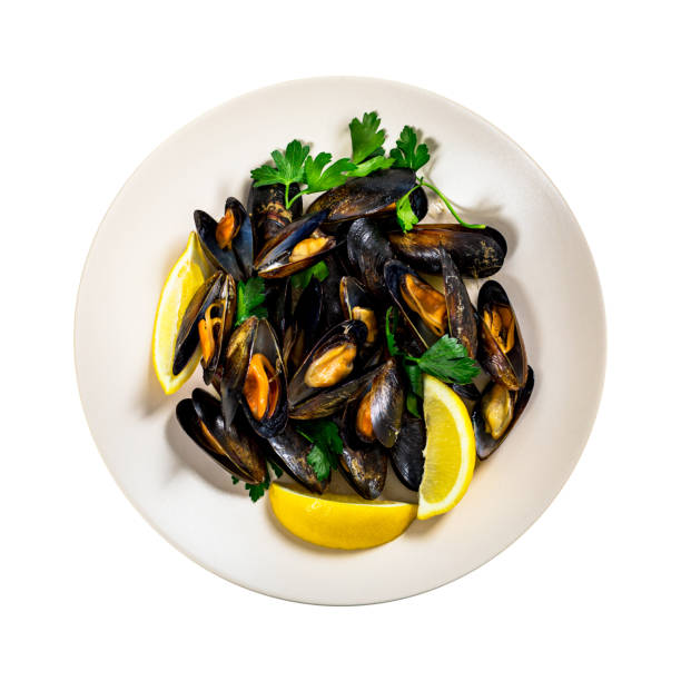 Delicious Seafood Mussels with Lemon and Parsley. Clams in the Shells Isolated on White Background. Selective focus.