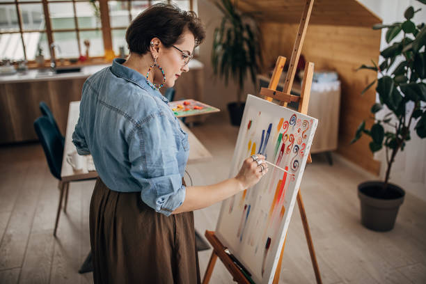 istock One young artist with eyeglasses painting in her studio 1251741898