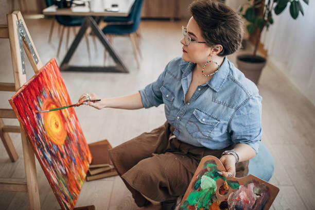 istock Artist with eyeglasses working in her studio 1251742020