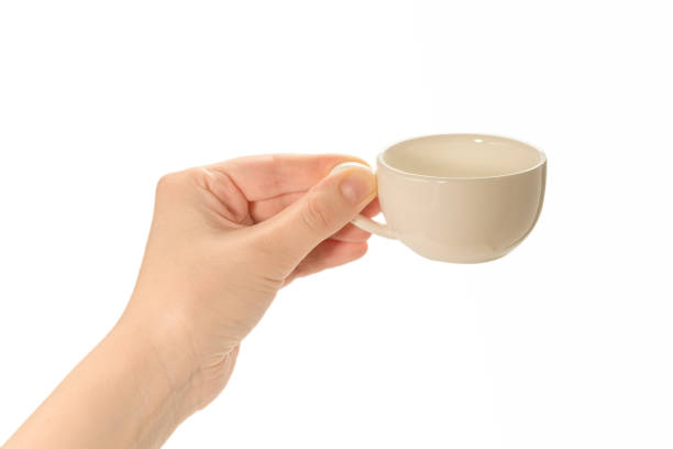 istock Empty coffee cup in woman hand isolated on white. 1251742143