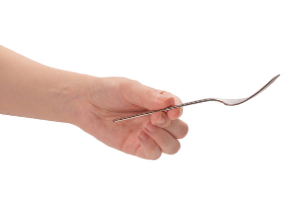 istock Fork in woman hand isolated on white. 1251742146