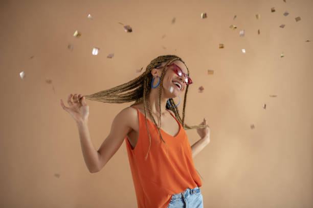istock Happy young African American female dancing under flying glitter 1251743587