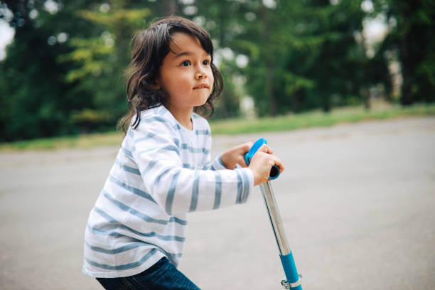 istock Kid on a scooter in the park 1251743910