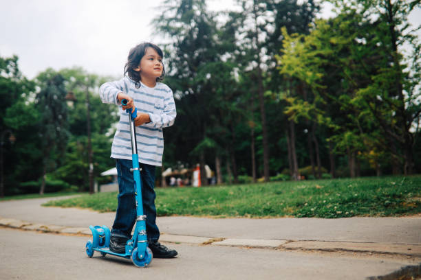 istock Kid on a scooter in the park 1251744693