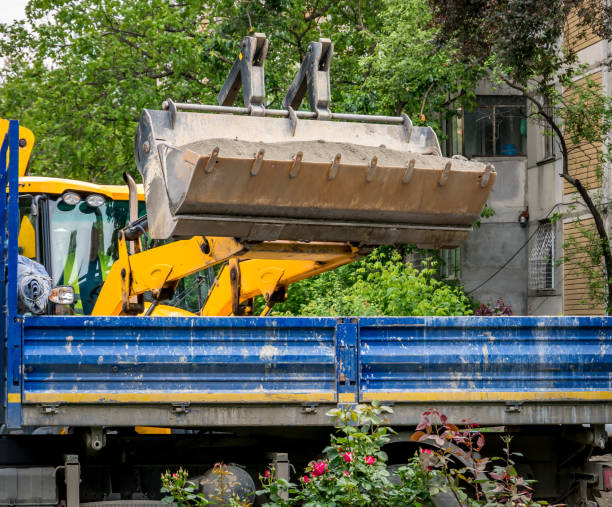 istock Backhoe loader loading sand or dirt in a vehicle. Construction equipment. 1251750443
