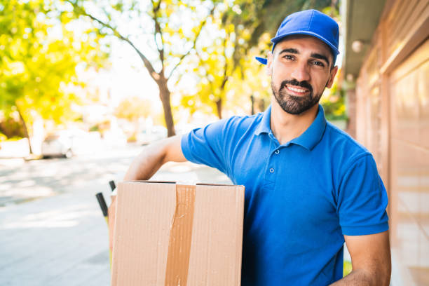 istock Delivery man carrying package outdoors. 1251759654