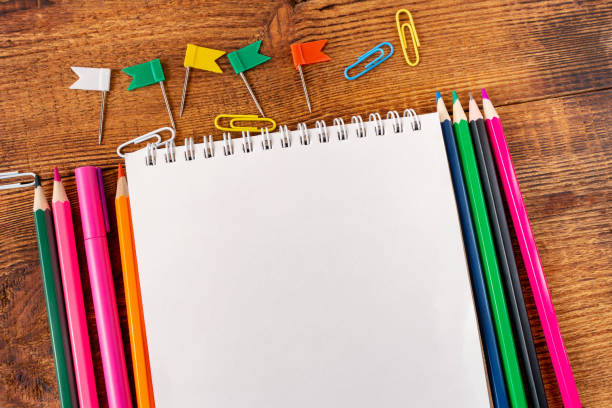 istock composition with notebook blank page colorful pencil, marker and pen mock-up Back to school concept 1251761405
