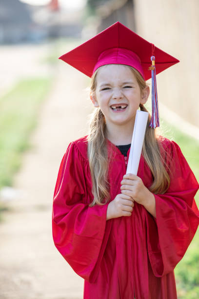 istock Young girl graduating kindergarten and smiling 1251791782