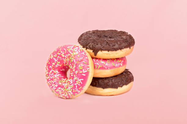 istock Multicolored donuts glazed on pastel pink background 1251824969