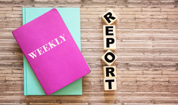 istock On a wooden table, cubes with the text Report and colored diaries. 1251824998