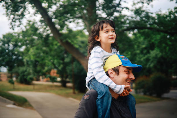 istock Father carrying kid on his back 1251853608