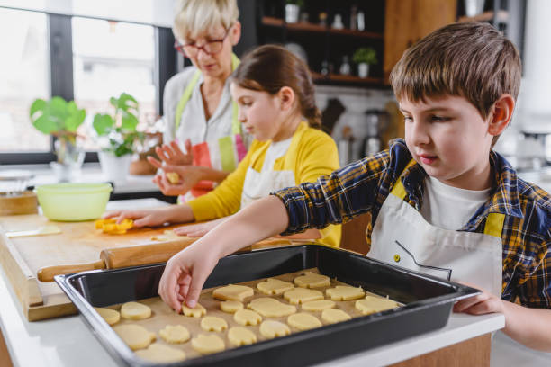 istock Children's hands making biscuits with help of cutting molds 1251862947