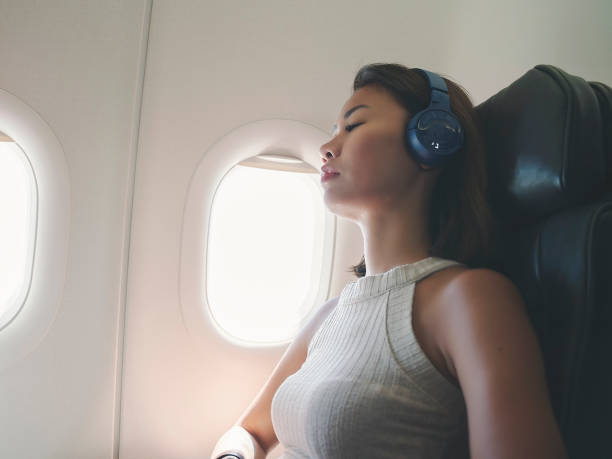 istock Woman napping in airplane 1251863986