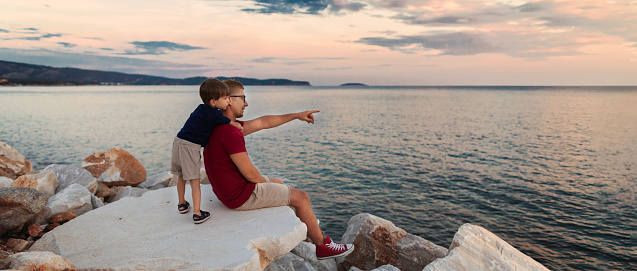 Family sitting on a rock