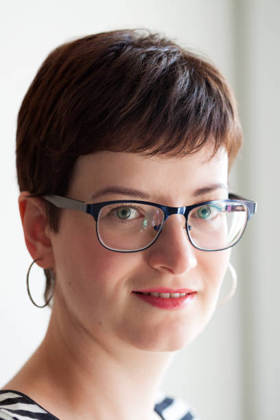 istock A beautiful short-haired brunette smiles and looks straight. 1251869426