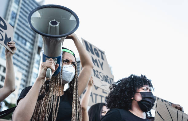 istock Activist movement protesting against racism and fighting for equality - Demonstrators from different cultures and race protest on street for equal rights - protest protests city concept 1251874183