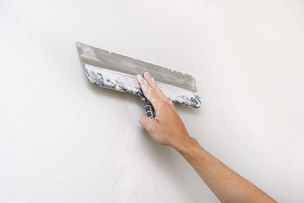 istock home improvement - putty knife in hand 125187654