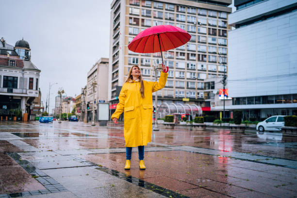 istock Cheerful woman with red umbrella 1251887125