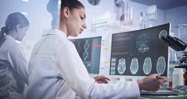 Female research team studying brainwave scanning Scientists examines brainwave models in modern Neurological Research Laboratory. neuroscience stock pictures, royalty-free photos & images