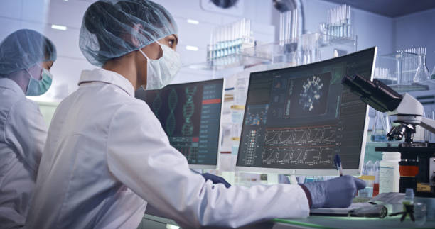 istock COVID-19 - laboratory team working on coronavirus vaccine. Protective workwear 1251892843