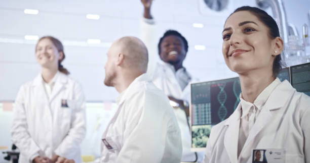 istock Multi ethnic laboratory team celebrating breakthrough in research 1251893369