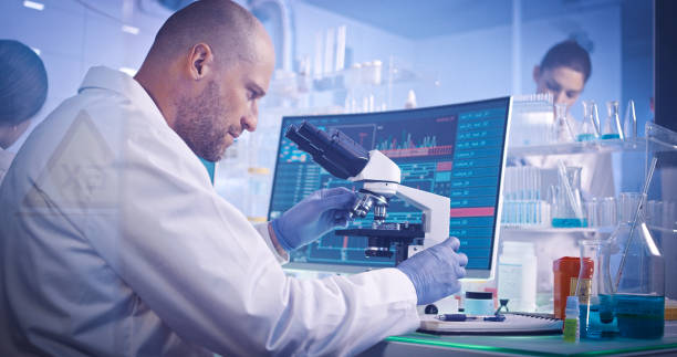 istock Research team studying DNA mutations. Female doctor in background 1251893373