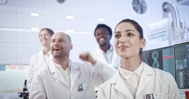 istock Multi ethnic laboratory team celebrating breakthrough in research 1251893952