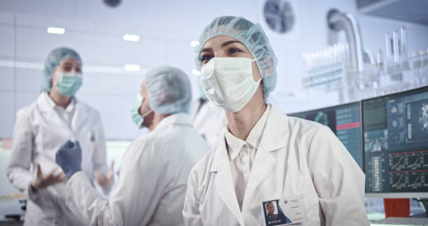 istock Multi ethnic laboratory team celebrating breakthrough in biohazardous research 1251894542