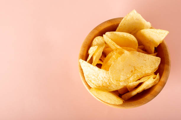 istock potato chips in a bowl on pink background 1251901031