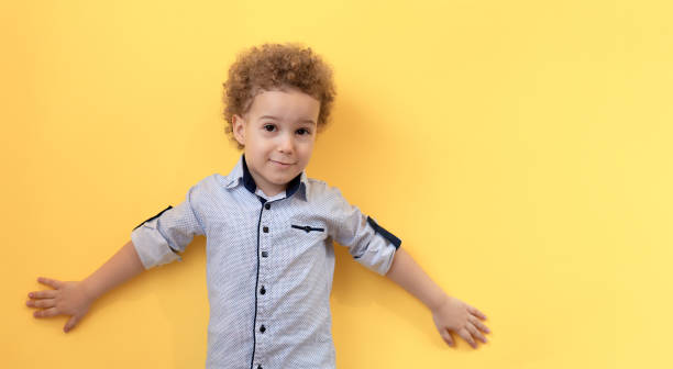 istock Portrait of boy with raised hands up 1251907668