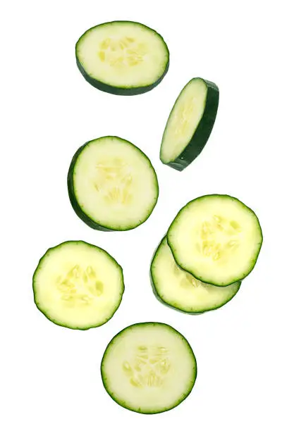 Flying vegetables. Seven slice of cucumbers isolated on white for packaging design and advertising. full depth of field. Clipping path included.