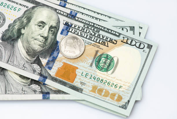 istock A bundle of 100 dollars and ruble coin on white background 1251917027