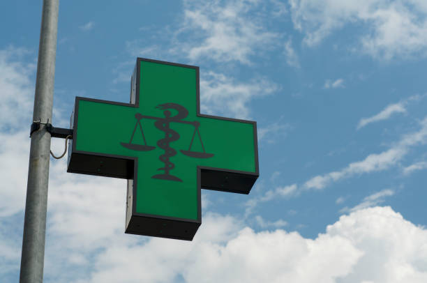 logo farmacia generica contro cielo blu a lugano - green cross foto e immagini stock