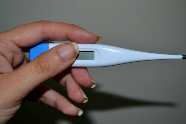 istock A Lady Holding A Temperature Thermometer 1251921968