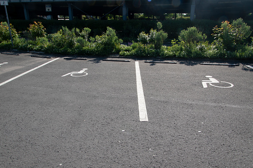Arrows, markings and pictograms on an asphalt parking lot.