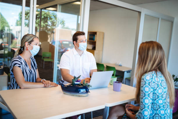istock Small Business Meeting With Workers Wearing Face Masks 1251922209