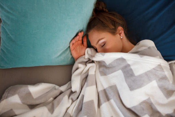istock Directly above young woman sleeping peacefully in her bed 1251922492