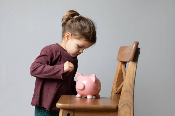 istock Toddler with Piggy Bank 1251922554