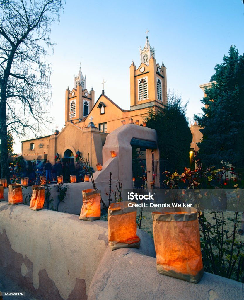 Luminaries in front of San Felipe de Neri Church in Albuquerque Christmas time in New Mexico with luminaries lined along the street in front of San Felipe de Neri Church in Old Town Plaza Luminaria Stock Photo