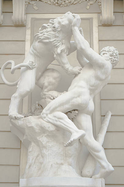 Sculpture of the ancient man holding a mad horse isolated on white backgound.