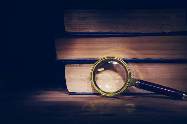 istock magnifier and books on the table 1251937041