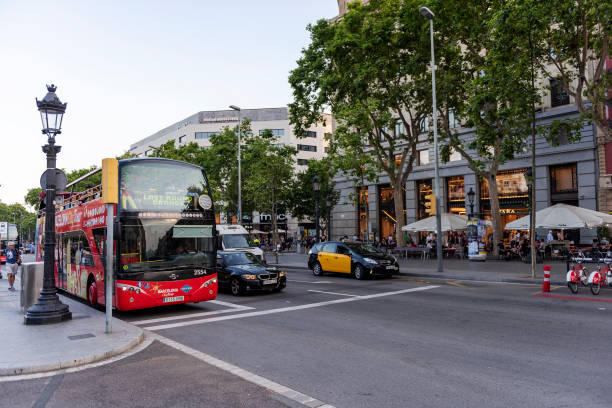 coach bus waiting at bus stop in plaza de catalunya (catalonia square), barcelona, spain - bus coach bus travel red imagens e fotografias de stock