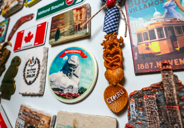 World travel destinations souvenir fridge magnets Berlin, Germany - June 14, 2020: Souvenir fridge magnets of global destinations and landmarks, with focus on a Welsh lovespoon magnet. round the world travel stock pictures, royalty-free photos & images
