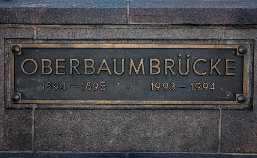 Berlin, Germany - June 21, 2020:  Close up of the plate of Oberbaum Bridge in Berlin. The text on the metal sign says \